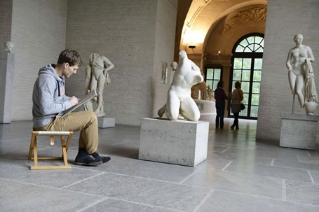 Ein Besucher der Glyptothek lässt sich von einer antiken Plastik inspirieren