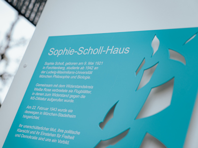 Die Plakette am generalsanierten Sophie-Scholl-Haus (© StMWK/Axel König)